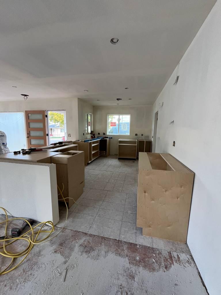 Interior room with drywall and ceiling lighting preparations completed.