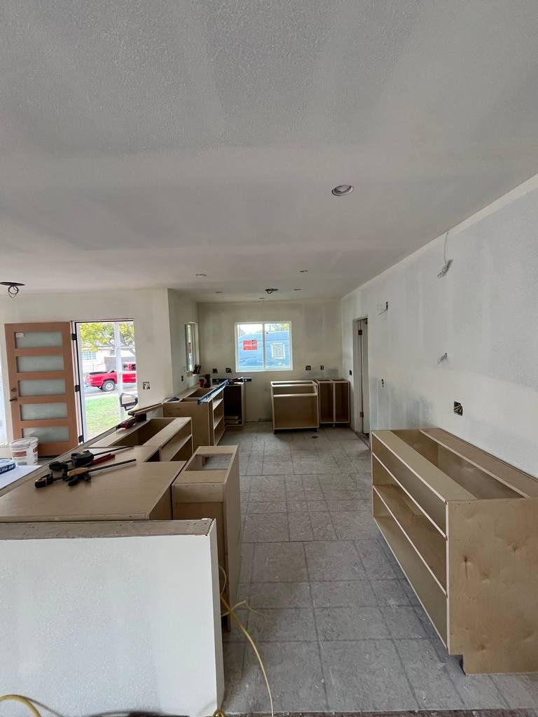Interior room renovation with wood-framed glass door installed.