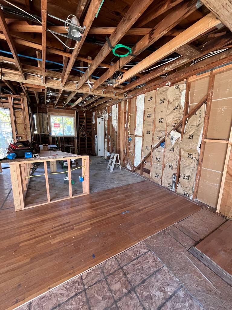 Kitchen renovation with exposed insulation and wiring