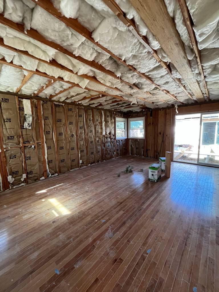 Large room with insulation and wood flooring. (03)