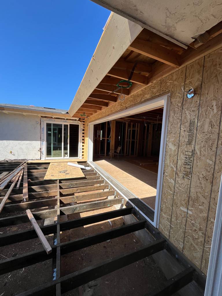 Outdoor deck framing under construction with partial sheathing